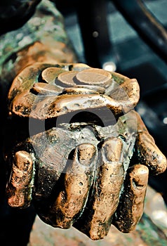 Pouch and coins in the man`s hand
