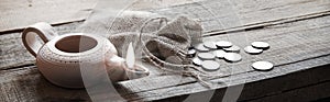 Pouch with silver coins on a wooden table