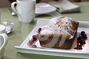 Pound Cake Loaf With Citric Sugar and Red Cherries In Syrup on a Rectangular Ceramic Plate