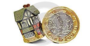 Pound gold coin toppling home property mortgage unstable house finance photo