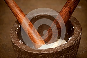 Pounding rice in a mortar.