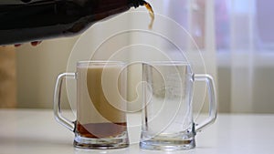 Pour beer into two glass mugs