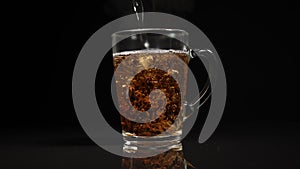 Pour boiling water into a mug of tea. Slow motion