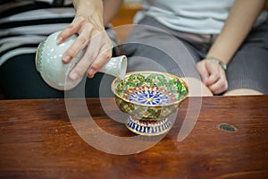 Pour ceremonial water with porcelain