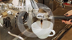 Pour coffee from a professional machine into a cup