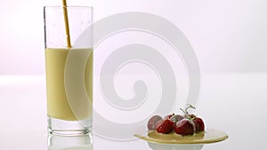 Pour into a glass yogurt,a milkshake with strawberries,on a white background,close-up.