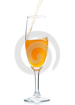Pour orange soda into Champagne  glass isolated on white background