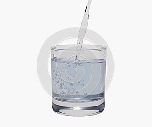 Pour water in glass isolated on white background with clipping path