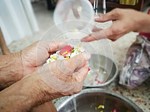 Pour water on the hands of revered elders and ask for blessing