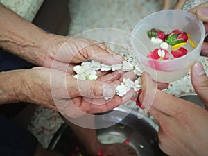 Pour water on the hands of revered elders and ask for blessing