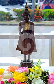 pour water over a Buddha statue