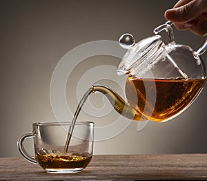 poured from a teapot cup of tea on a wooden table