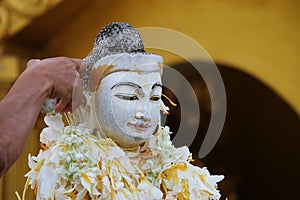 Pouring acrivity on white Buddhism statue