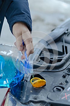 Pouring antifreeze liquid for washing car screen