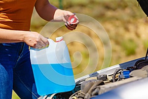 Pouring antifreeze liquid for washing car screen