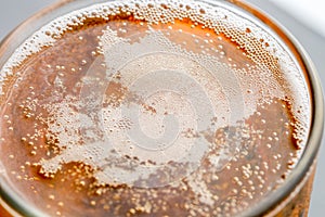 Pouring beer with bubble froth in glass for background