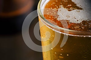 Pouring beer with bubble froth in glass for background