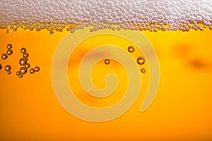 Pouring beer with bubble froth in glass for background