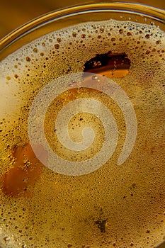 Pouring beer with bubble froth in glass for background