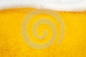 Pouring beer with bubble froth in glass for background and design