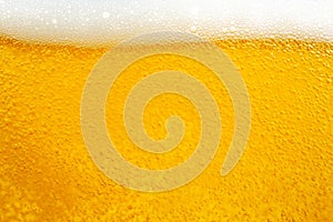 Pouring beer with bubble froth in glass for background and design