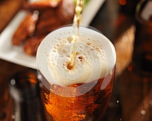 Pouring beer into glass photo