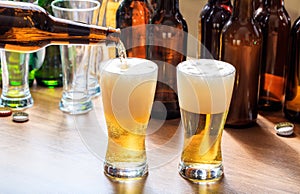 Pouring beer in a glass of beer on a pub background