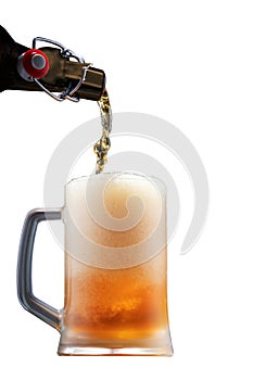 Pouring beer into a glass from the bottle, fresh foaming beer, isolated