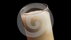 Pouring Beer in Glass From Bottle, Making Foam. Close Up Spinning Full Frame