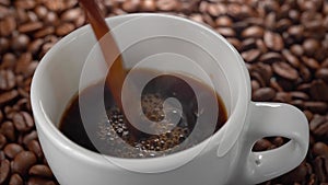 Pouring black coffee to a cup