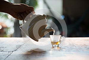 Pouring the black tea in a glass