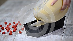 Pouring cake mix into baking tin.