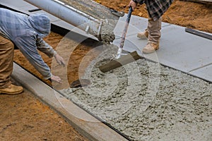 Pouring cement during concrete sidewalk