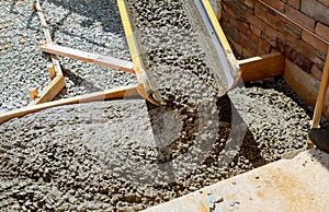 Pouring cement during paving concrete pavement near the house