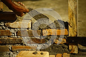 Pouring cements to layer bricks structure photo