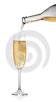 Pouring champagne from a bottle in glass