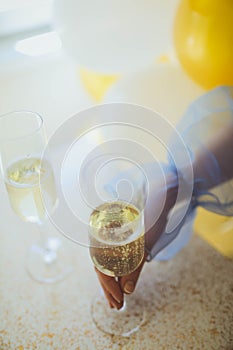 Pouring champagne in flutes standing on table