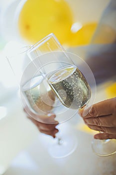 Pouring champagne in flutes standing on table