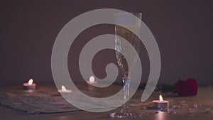 Pouring champagne in a glass in slow motion, romantic scene