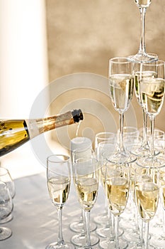 Pouring champagne into wine glasses