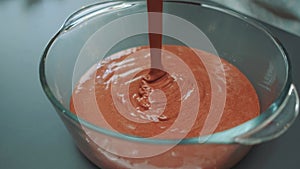 Pouring chocolate batter into a baking dish