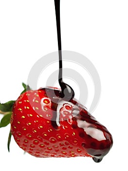 Pouring chocolate sauce on strawberry