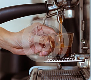 Pouring coffee into a cup of coffee