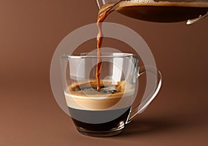 Pouring coffee in glass cup