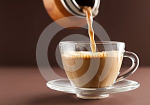 Pouring coffee in glass cup