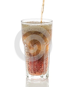 Pouring cola into glass with ice cubes isolated