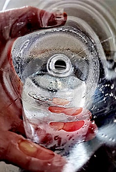 Pouring cold water from a bottle, shot from inside the bottle.