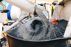 Pouring concrete from a concrete mixer to the pump - pouring con