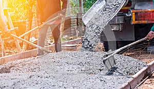 Pouring concrete mix on floor from truck in construction site