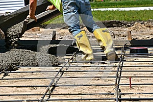 Pouring concrete on a new driveway site.